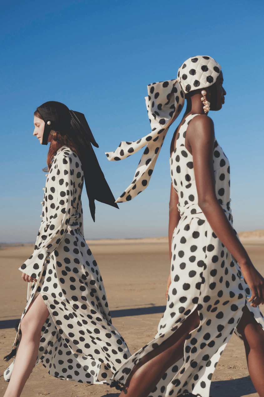 Models wear black and white polka dot dresses from the Mother of Pearl SS19 collection