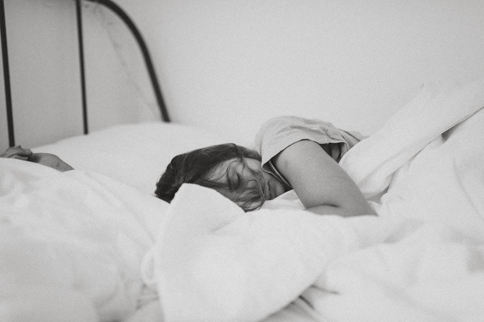 Black and white photo of woman sleeping