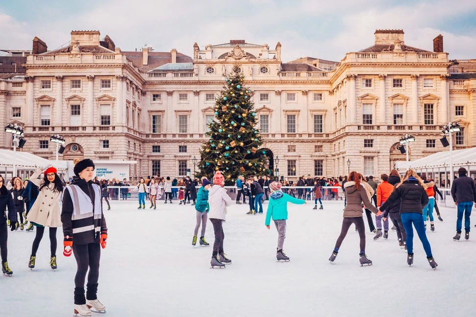 Ice Skaters Glide Around The Rink In Front Of The Christmas Tree At Somerset House