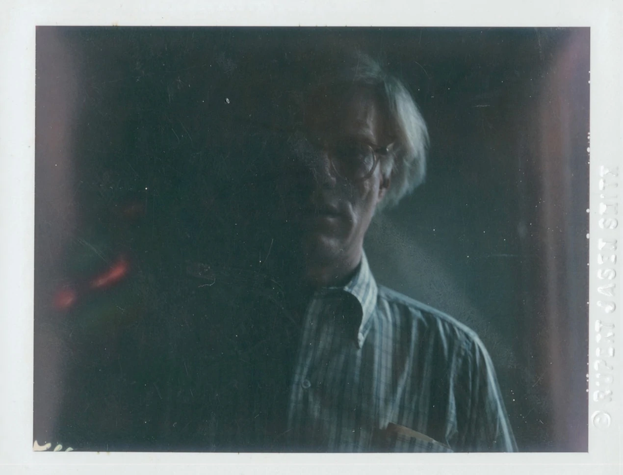 A self-portrait photograph of pop artist Andy Warhol